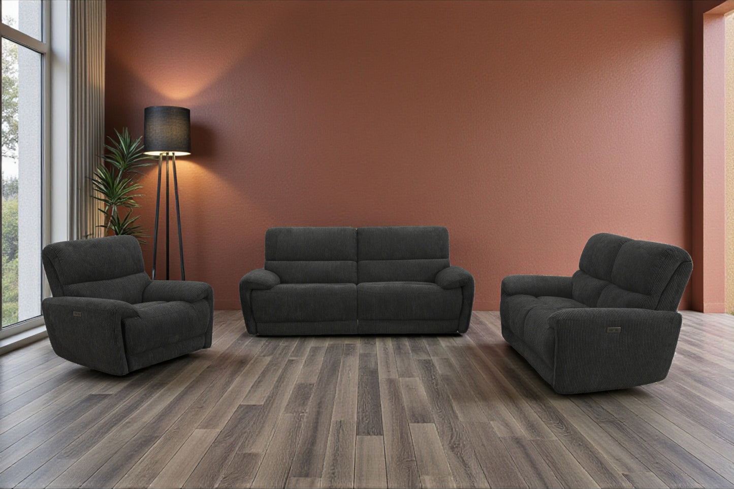 Gray sofa set in a modern living room with wooden floor and large windows.
