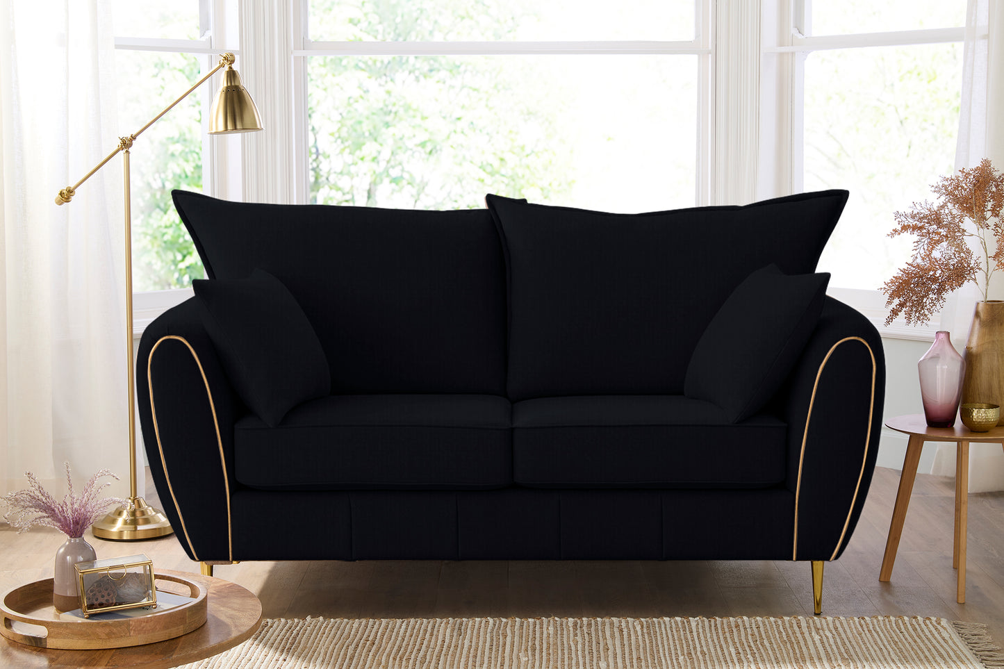 Black sofa with gold trim in a living room setting