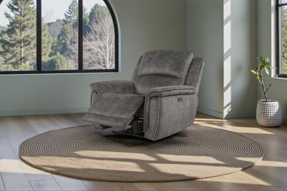 Gray recliner chair in a room with large windows and a plant.