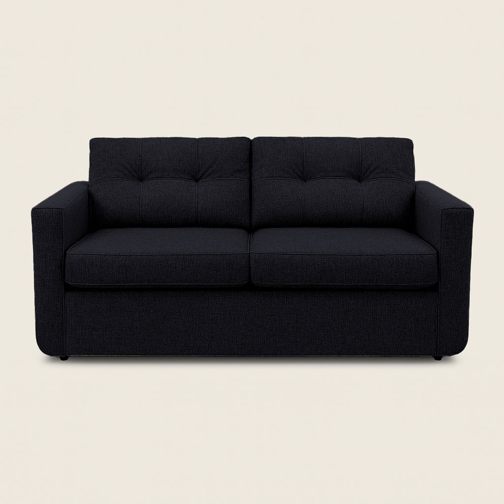 Black sofa on a beige background