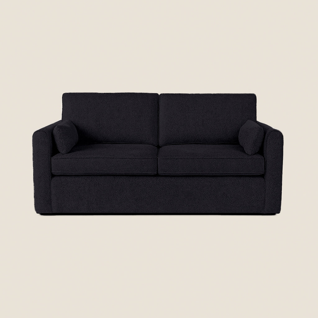 Black sofa on a beige background