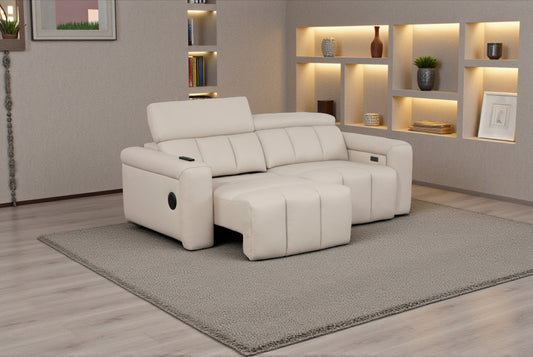 Beige sectional sofa in a living room setting with shelves and decor.