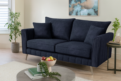 Navy blue sofa in a living room setting with decor elements.