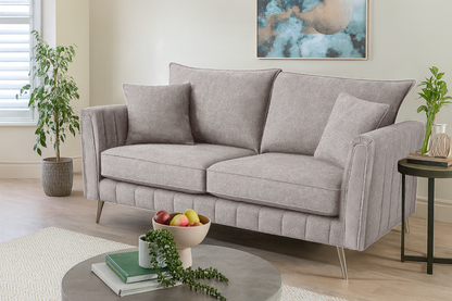 Gray sofa in a living room with decorative items and plants.