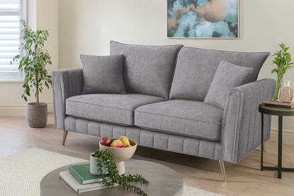 Gray sofa in a living room setting with decor elements.
