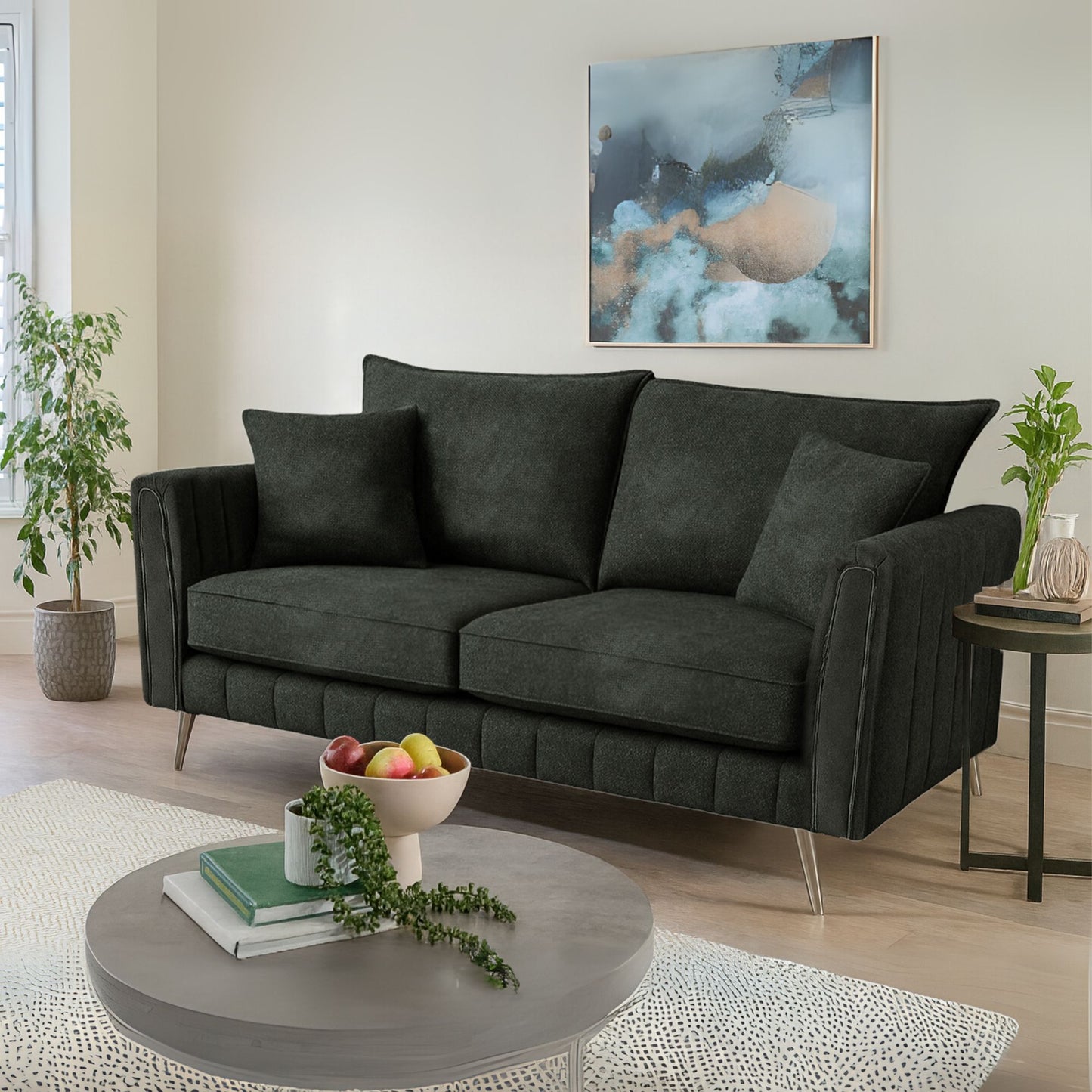 Modern living room with a dark gray sofa, round coffee table, and abstract art on the wall.