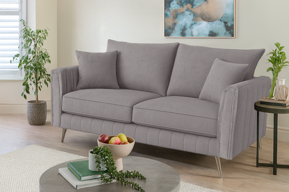 Gray sofa in a living room with decorative items and plants.