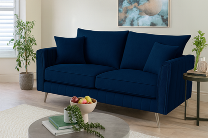 Blue sofa in a living room with decorative items and plants.