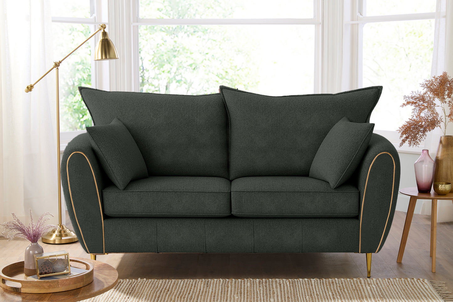 Dark gray sofa with cushions in a living room setting