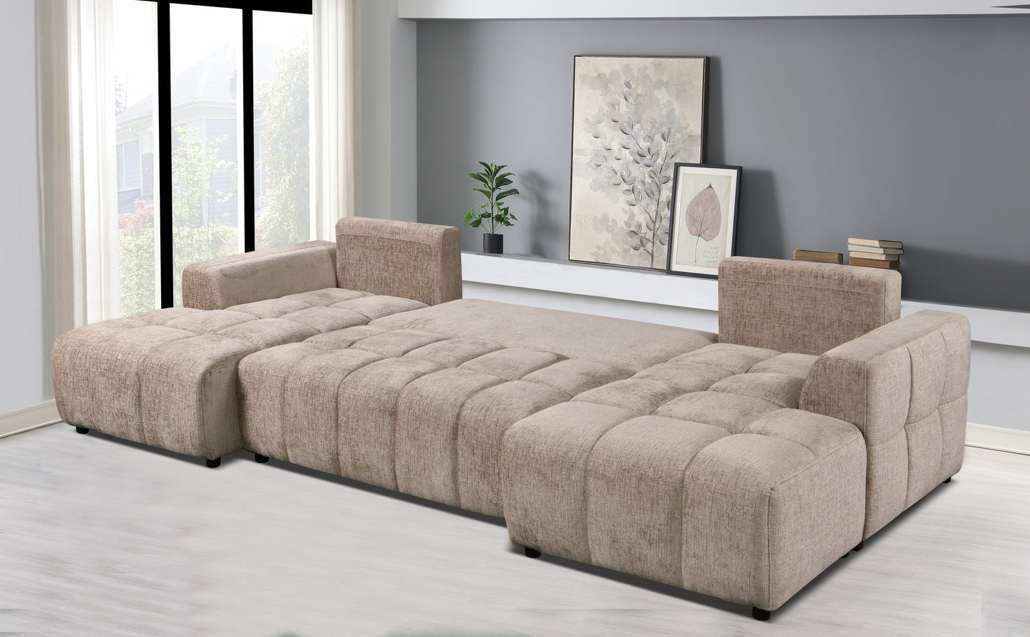 Beige sectional sofa in a living room setting with artwork on the wall.