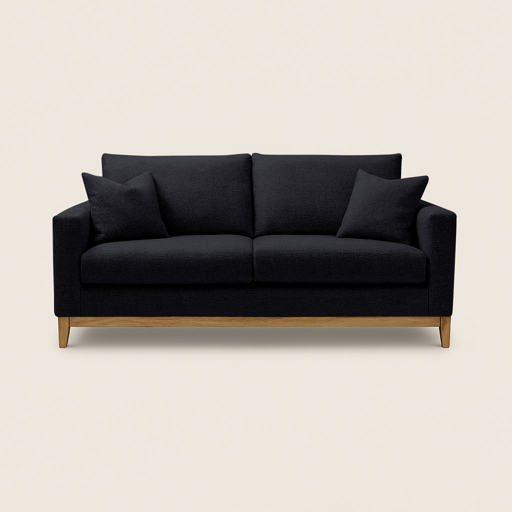 Black sofa with wooden legs on a beige background