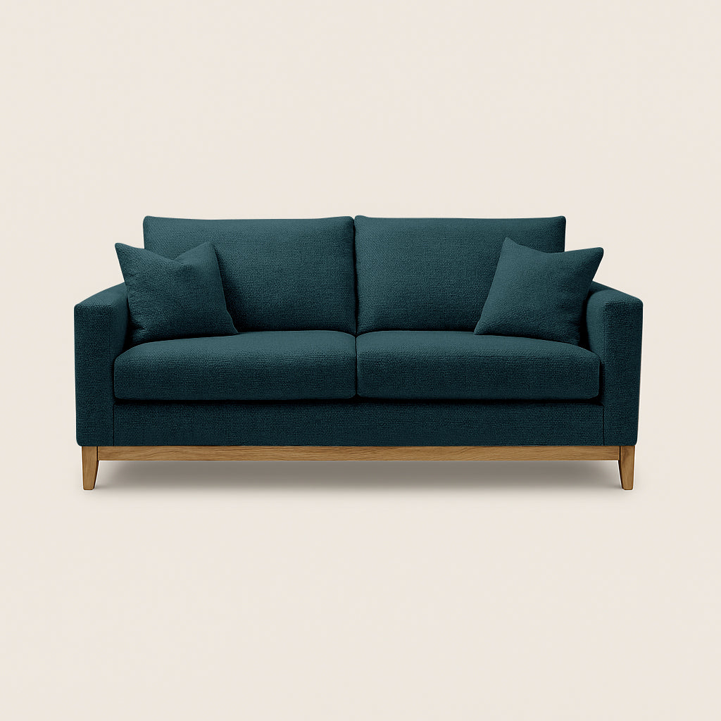Teal sofa with wooden legs on a beige background