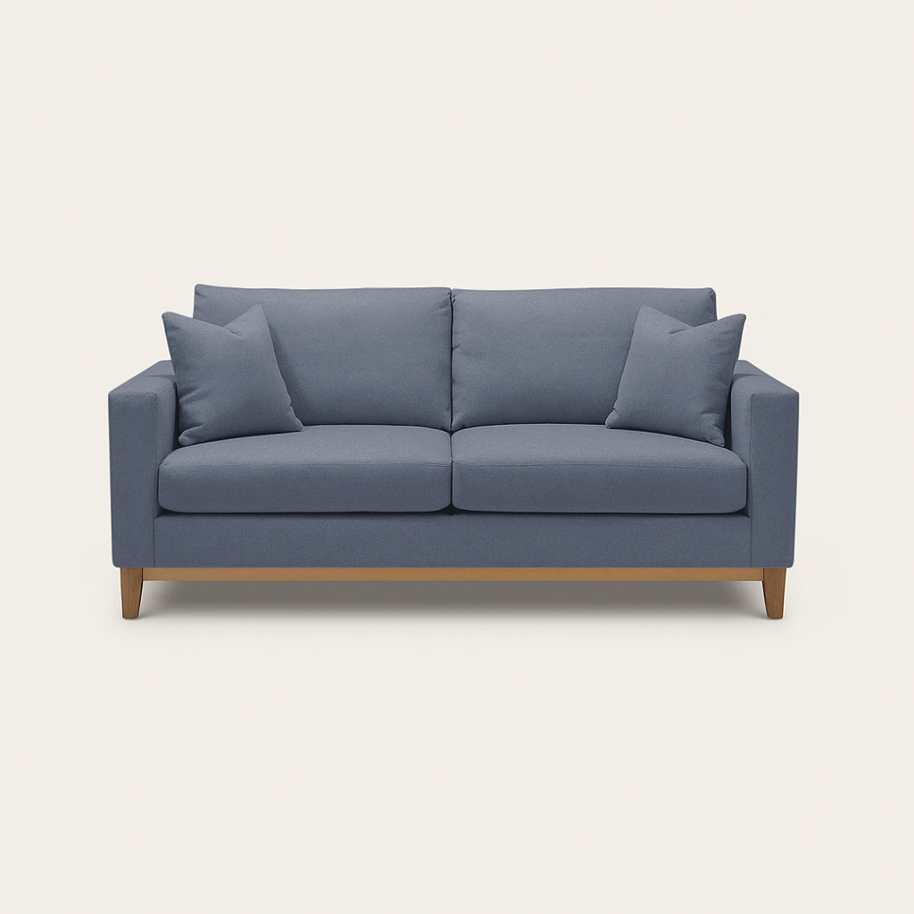 Blue sofa with wooden legs on a white background