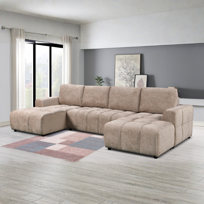 Beige sectional sofa in a modern living room with a gray wall and large window.