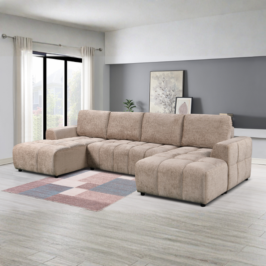 Beige sectional sofa in a modern living room with a gray wall and large window.